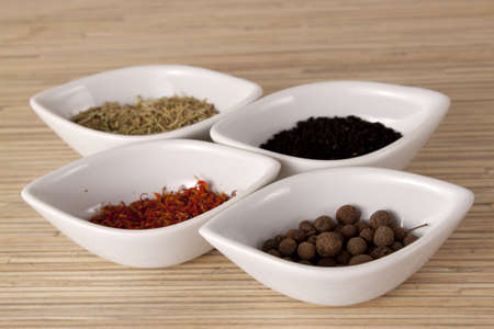 Colorful relishes in white bowls in the shape of teardropsの写真素材