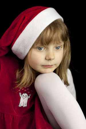 Pretty girl in a red dress Santa Clauseの写真素材