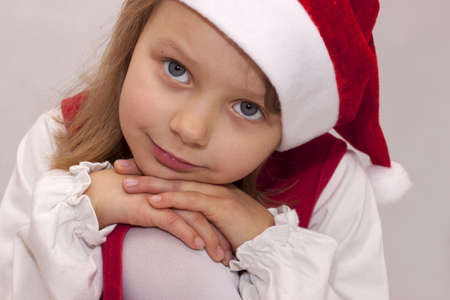 Pretty girl in a red dress Santa Clauseの写真素材