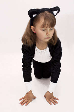 Pretty girl dressed as a cat on white backgroundの写真素材