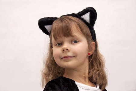Child dressed as a cat on white backgroundの写真素材