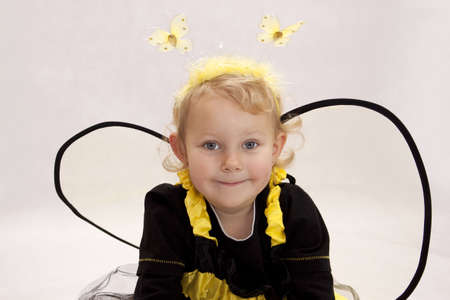 Small girl dressed as a bee on white backgroundの写真素材