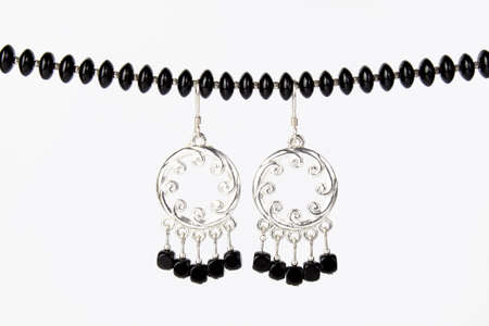 Black necklace and silver earringsの写真素材