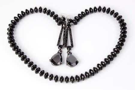 Earrings and necklace in the shape of heartの写真素材