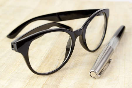 Eyeglasses and pen on old papyrusの写真素材