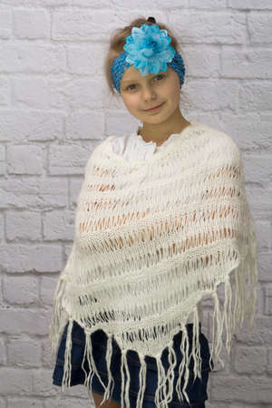 Girl with blue flower on her head and ponchosの写真素材