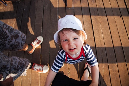 Adorable toddler trying to get some attention from his parentsの写真素材