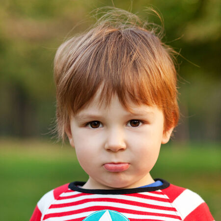 Close up portrait of beautiful boy pouting, shallow depth of fieldの写真素材