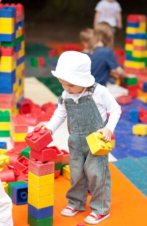 Cute two year old boy playing with toy blocksの写真素材