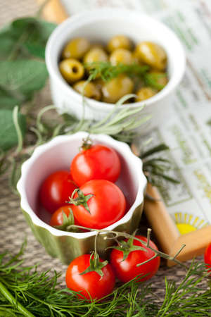 Close up of cherry tomato, olives and various herbsの写真素材