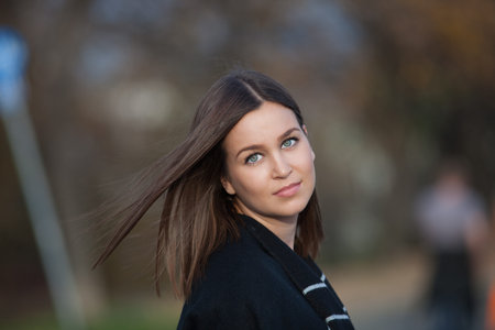 Outdoor portrait of beautiful young woman, shallow depth of field