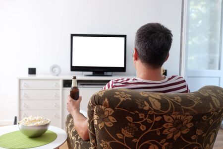 Image of a young man watching TVの写真素材