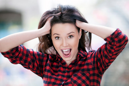 Portrait of young woman looking shocked, close up