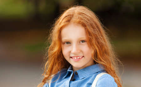 Close up portrait adorable little red-haired girlの写真素材