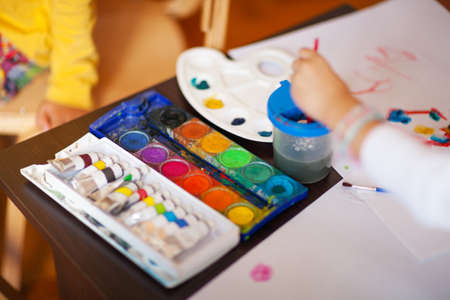 Various painting supplies on white paper, shallow depth of fieldの写真素材