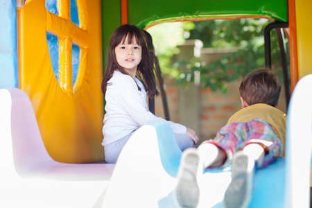 Boy and girl in the playground houseの写真素材