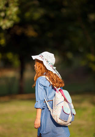 Image of little red-haired girl on her way to schoolの写真素材