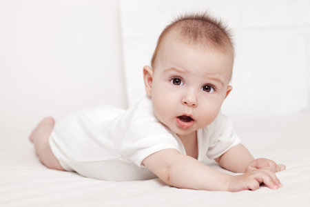 Portrait of a beautiful 6 months baby, on white background