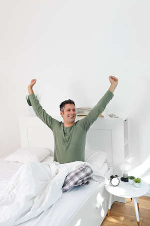 Young man waking up fully restedの写真素材