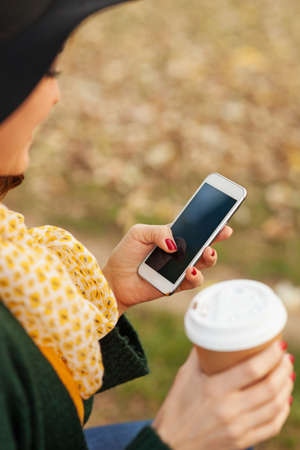 Young woman using a smart phone outdoors, shallow depth of fieldの写真素材