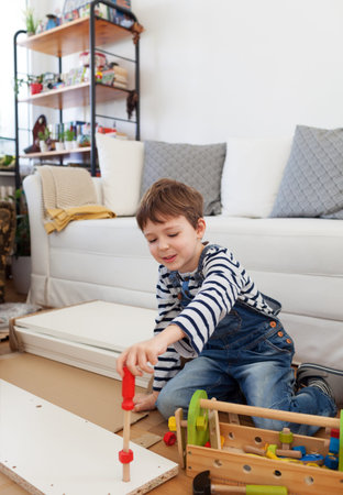 Father and son assembling furniture at homeの写真素材