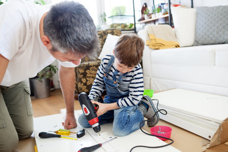 Father and son assembling furniture at home