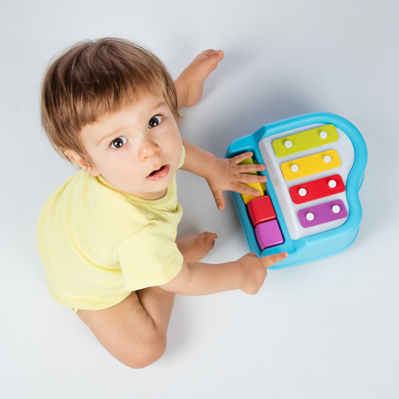 Baby boy playing toy pianoの写真素材