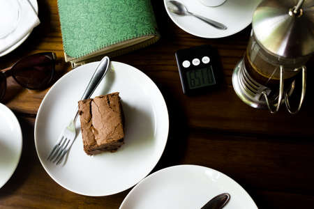 Brownie and green handmade notebook over a table (open). Coffee  decorating.の写真素材