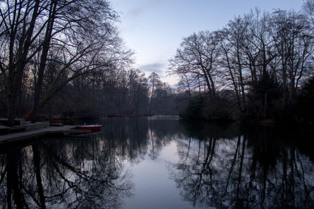 River in Tiergarten, showing water, trees and a boat.の写真素材