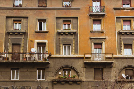 Several roman windows on a orange and brown wallの写真素材