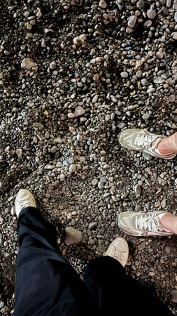 Feet against the backdrop of wet sand in the evening light.の写真素材