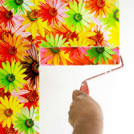 a paint roller with multi colored daisy flowersの写真素材