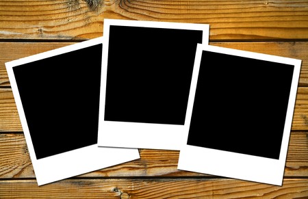 polaroids frames over old wooden boards brown colorの写真素材