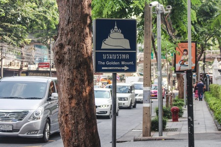 Bangkok, Thailand - October 2017: Tourist sign in Bangkoks busy street pointing to The Golden Mount or Wat Saket templeのeditorial素材