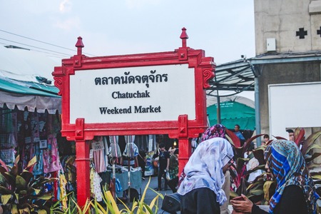 BANGKOK, THAILAND - October 2017: Sign of Jatujak or Chatuchak Market in Bangkok. Two Thai women wearing headscarves.のeditorial素材