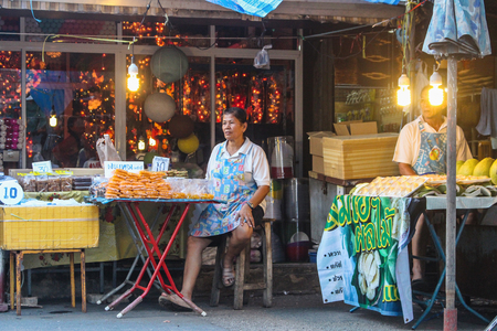BANGKOK, THAILAND - October 2017: Street vendor Thai woman in Chatuchak Market selling her handmade sweets and goods.のeditorial素材
