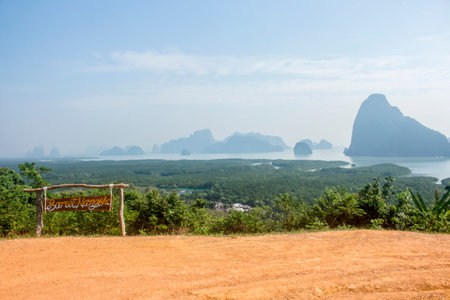 Phang-nga, Thailand - January 2018: Wooden sign at Samet Nangshe viewpoint, with limestone mountains in the distanceのeditorial素材
