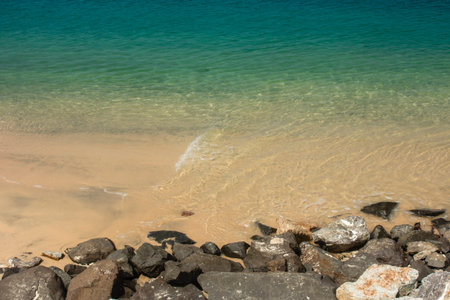 Abstract photo of golden sand beach under turquoise clear water. Summer paradise vacation concept,...