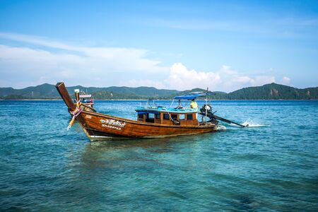 Phang Nga, Thailand - January 2018: Long-tail boat floating in Andaman Sea. Emerald water with mountains in the distanceのeditorial素材