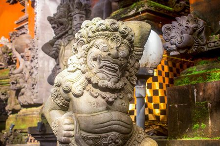 Close up of gray stone sculpture of the Bhoma creature at Ubud Palace in Bali.