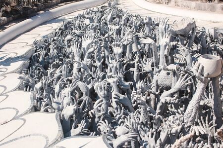 Chiang Rai, Thailand - November 2017: Hundreds of hands emerging from the ground sculpture. Wat Rong Khun, White Templeのeditorial素材