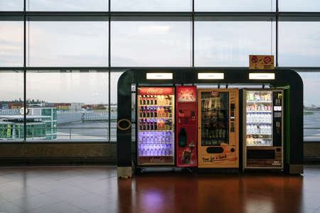 Porto, October 2019 - Drinks, snacks and chocolates vending machine in airport overlooking the landing stripのeditorial素材