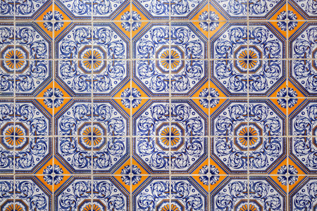 Pattern image of traditional ornate portuguese decorative tiles. Blue and orange azulejos