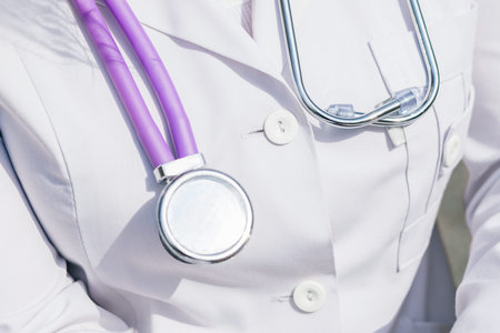 Medical doctor on white background with a stethoscope. Focus on the stethoscope.