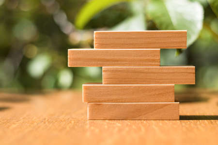 Wooden blocks stacked on top of each other to build a business strategy, success ladder in a business growth concept, copy spaceの写真素材