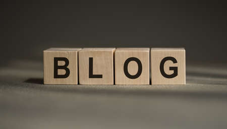 BLOG word written on a wooden block. BLOG text on a blue table with a wooden background for your design, concept.の写真素材