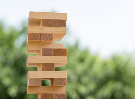 Wooden blocks stacked on top of each other to build a business strategy, success ladder in a...