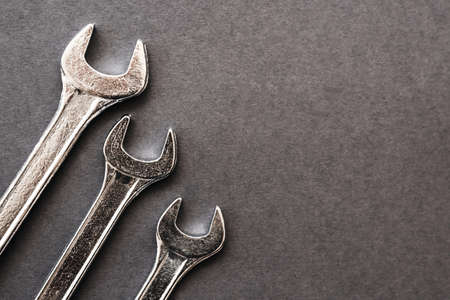 A set of mechanical keys of different sizes on a gray background. Photo for your designの写真素材