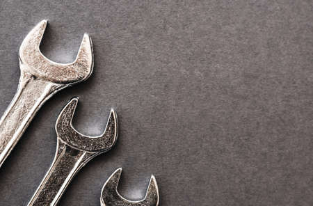 New wrenches on gray background, top view with space for text. Plumber toolsの写真素材
