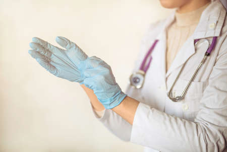 woman doctor wears medical gloves. medical conceptの写真素材